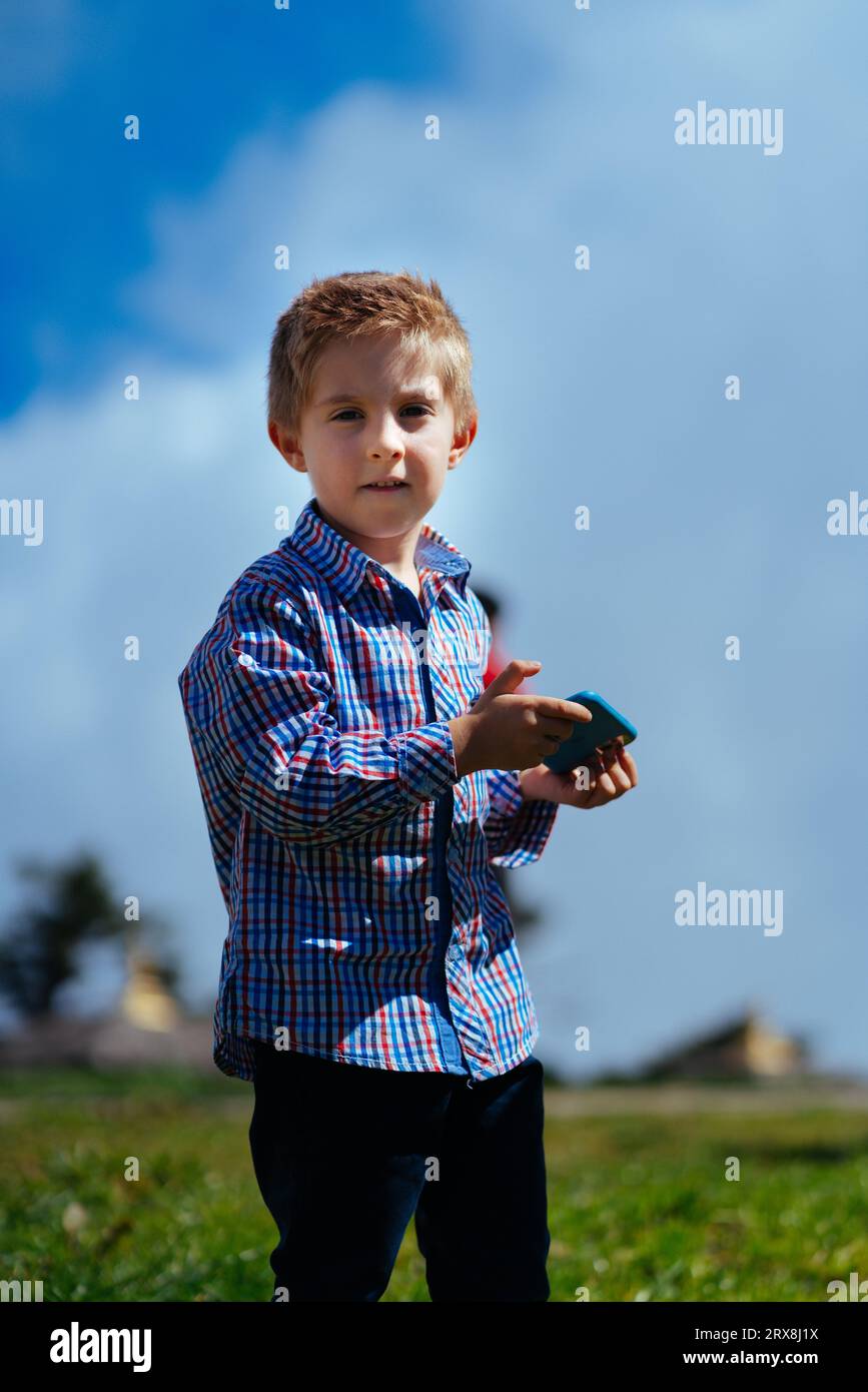 Young Caucasian boy playing on the phone Stock Photo