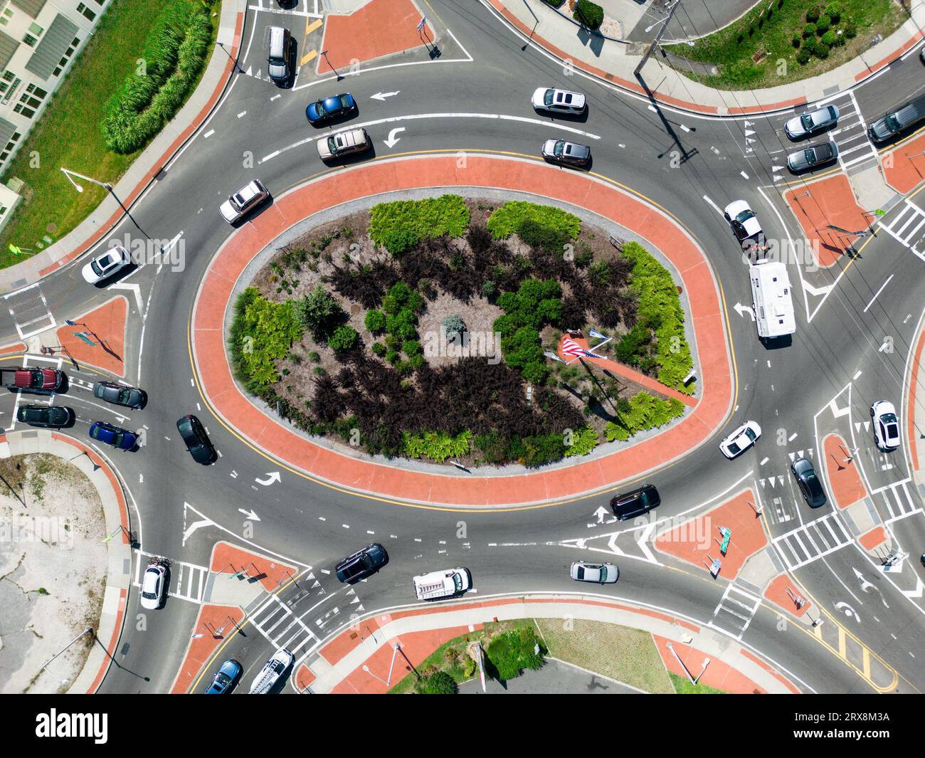 Aerial view of typical urban traffic circle with vehicles seen from overhead. Stock Photo