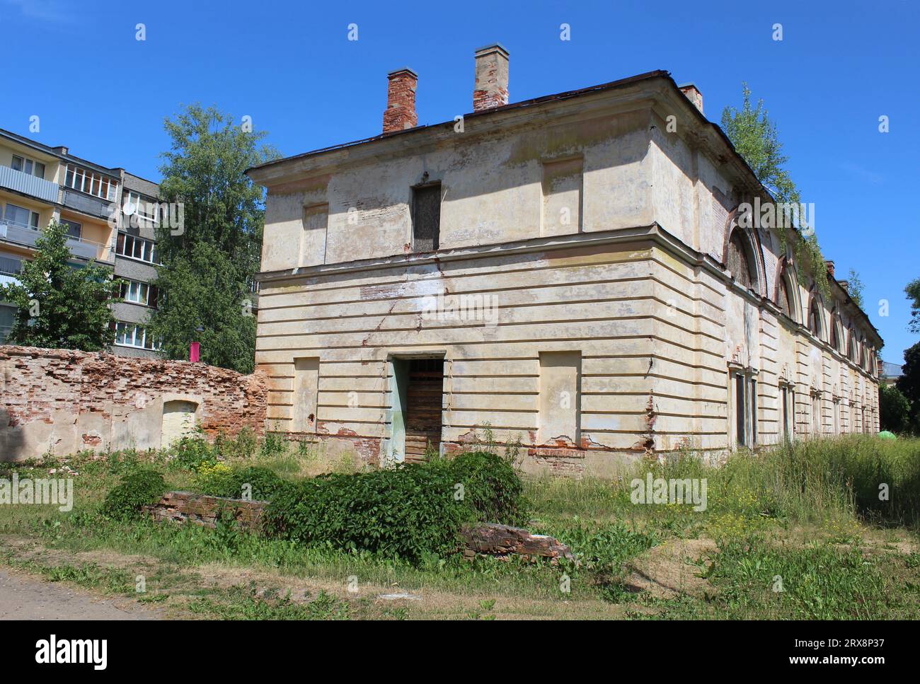 Abandoned building at Daugavpils Fortress with a Soviet era apartment building nearby Stock Photo