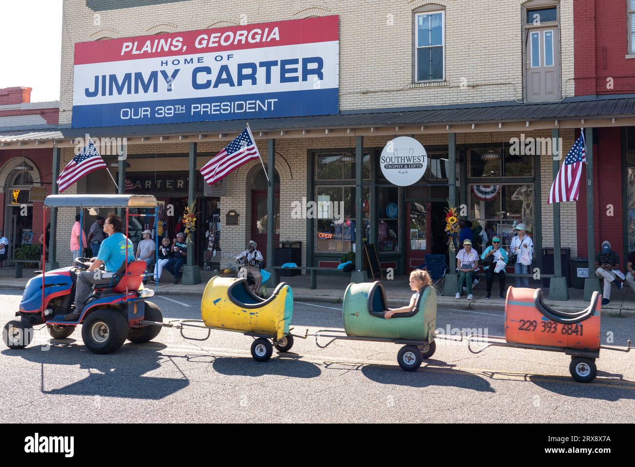 Plains, United States. 23rd Sep, 2023. A children's train made from barrels passes down Maine Street at the 26th annual Plains Peanut Festival in honor of former President Jimmy Carter, September 23, 2023 in Plains, Georgia. Former President Jimmy Carter and his wife Rosalynn Carter were briefly spotted at the festival inside a private vehicle. Credit: Richard Ellis/Richard Ellis/Alamy Live News Stock Photo