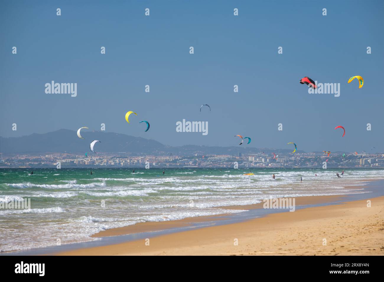 Kiteboarding kitesurfing kiteboarder kitesurfer kites on the ocean beach Stock Photo