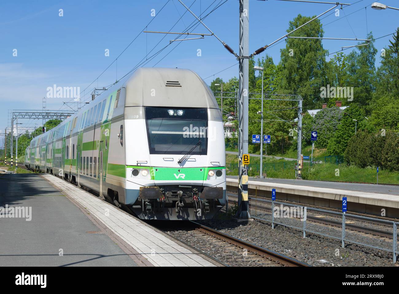 HAMENENLINA, FINLAND - JULY 10, 2017: Passenger train arriveson on the railway station on a sunny June day Stock Photo