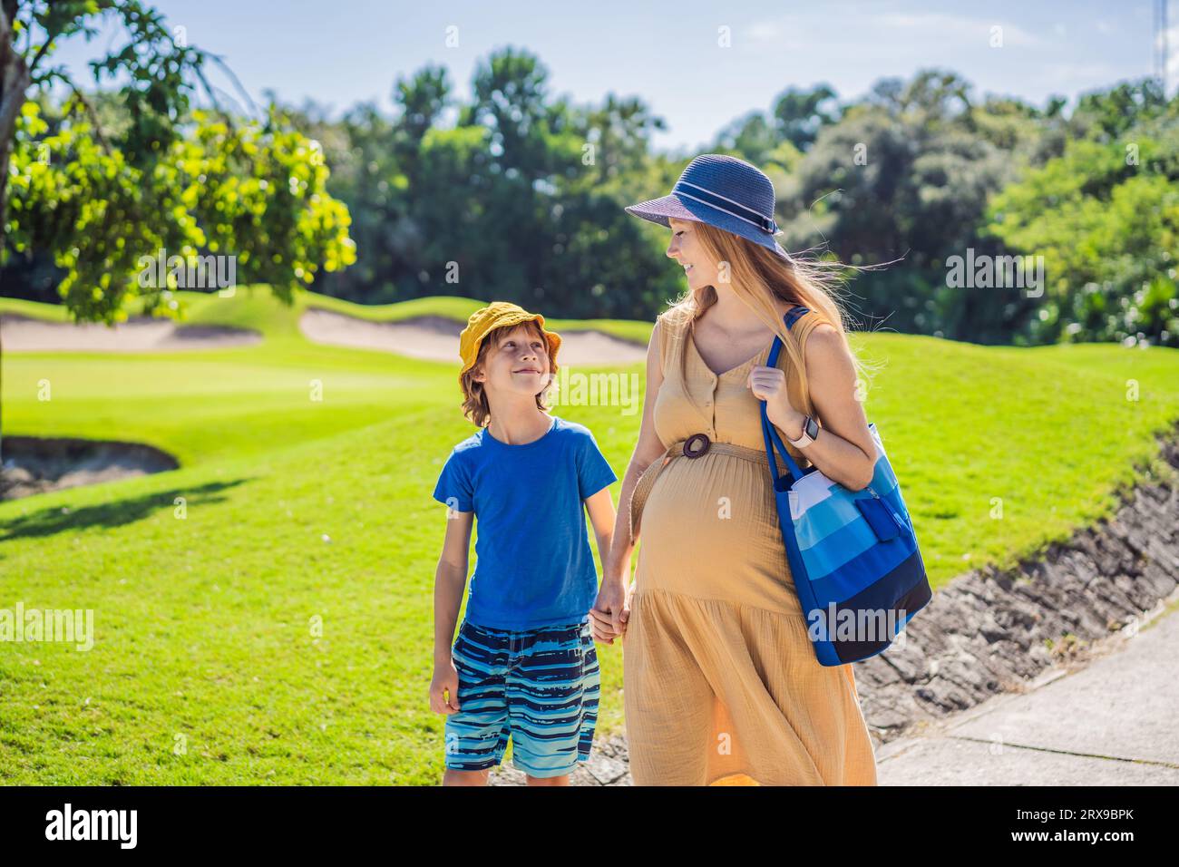 Expectant mother and her son enjoying a leisurely stroll in the