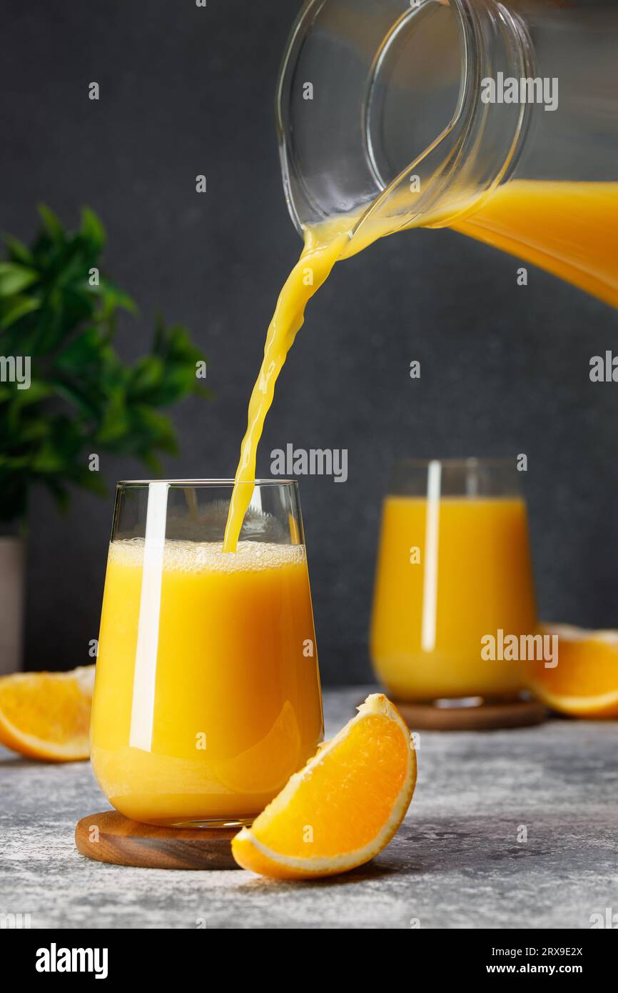 Pouring orange juice from a glass jug … – License Images – 138447 ❘  StockFood