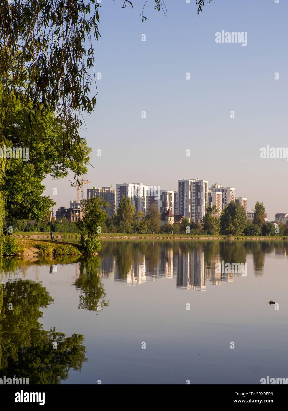 Residential complex in the park in the summer against the blue sky. New ...