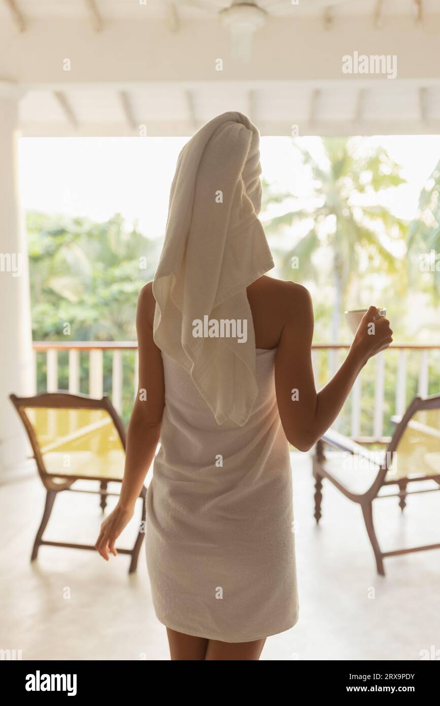 Good morning of beautiful girl on tropical villa. Back view of a happy