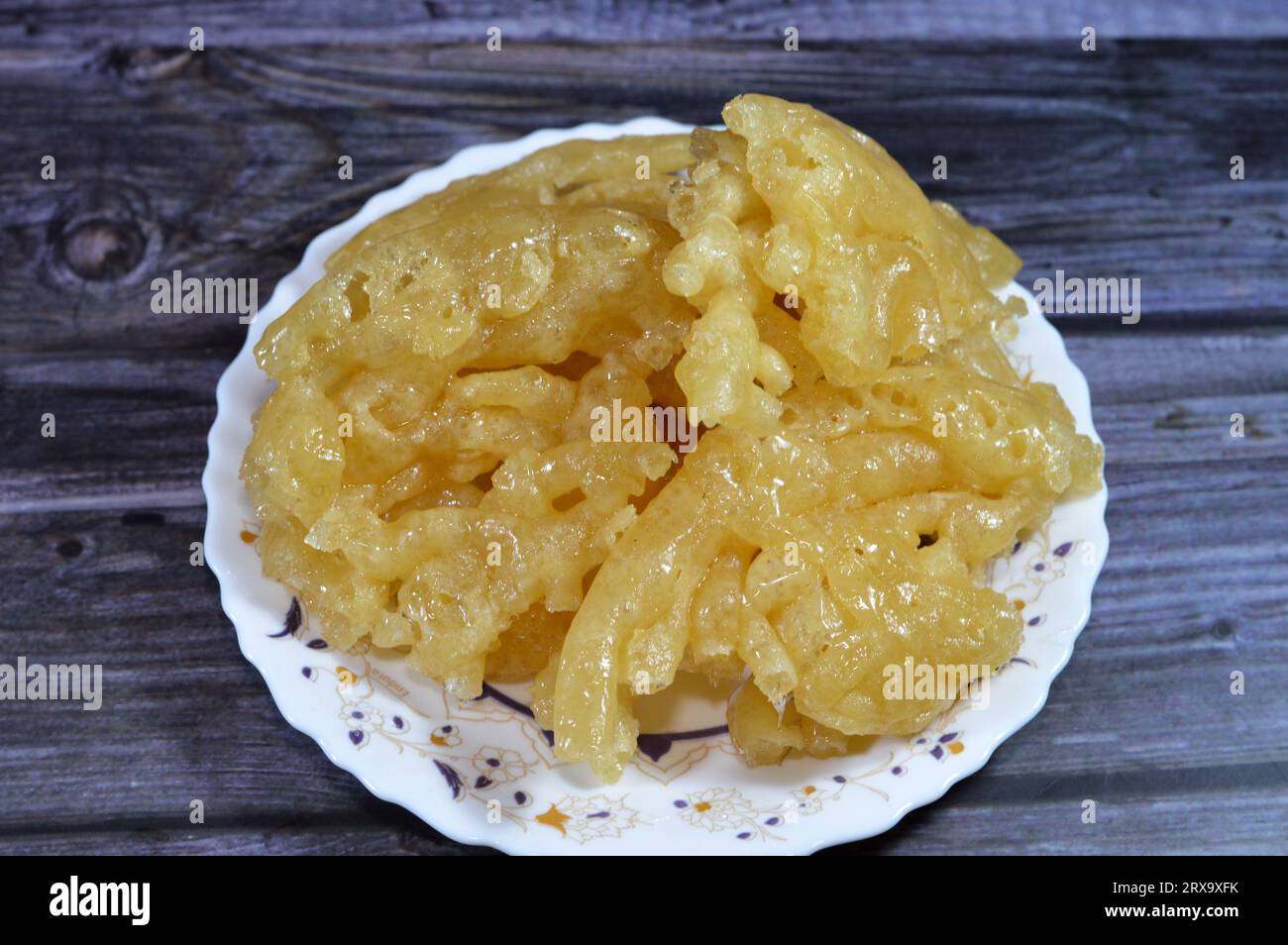 Egyptian Meshabek, It is a rounded sweet made of a deep-fried crunchy batter soaked either in honey or sugar syrup. Its name translates to (twisted), Stock Photo