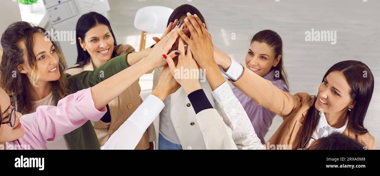 Group of cheerful young woman doing high five together Stock Photo
