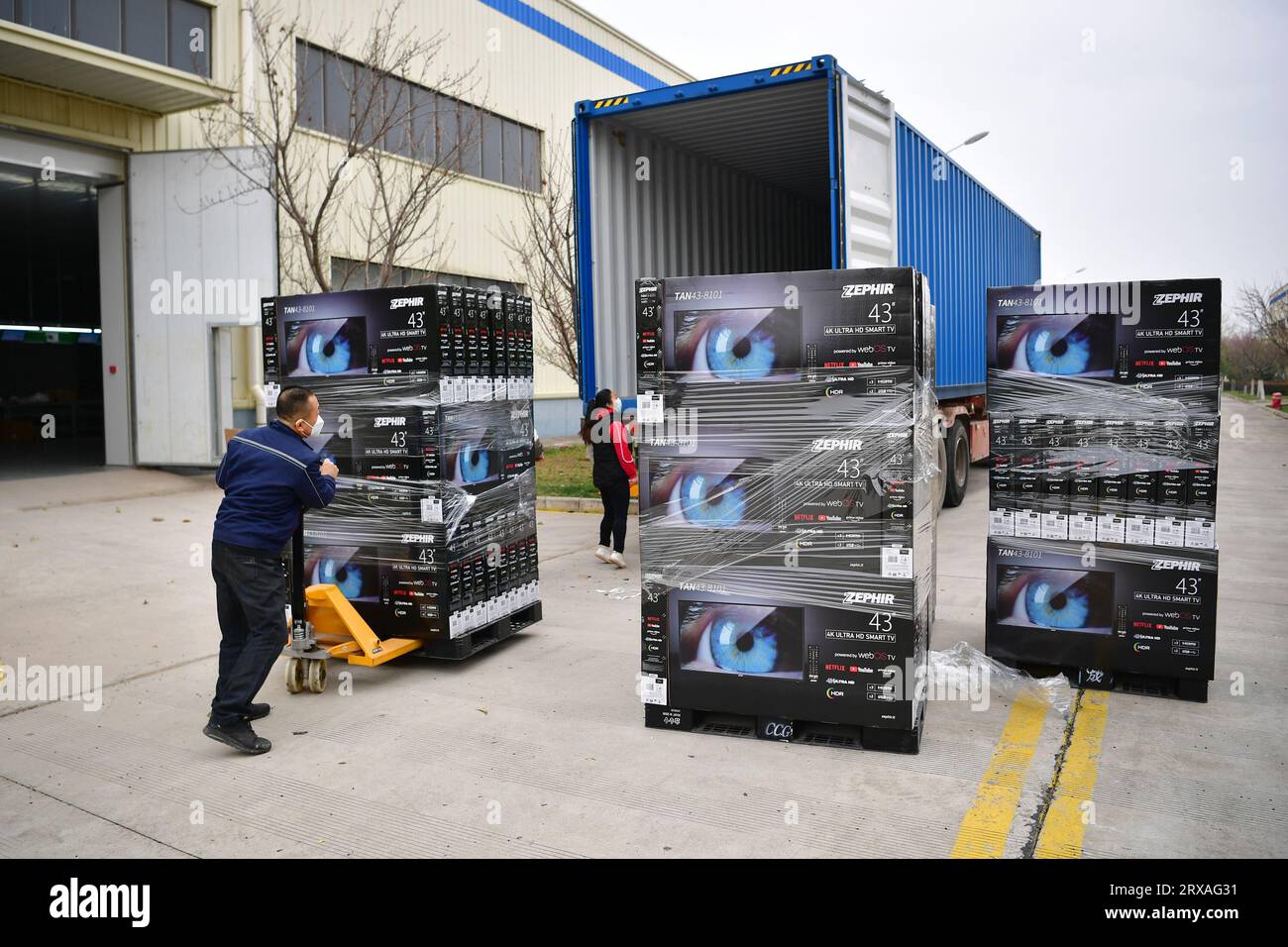 Xi'an, China's Shaanxi Province. 17th Mar, 2022. Workers load products at a company producing display devices near Xi'an International Port in Xi'an, northwest China's Shaanxi Province, March 17, 2022. The Chang'an China-Europe freight train service was launched in 2013, when China proposed the Belt and Road Initiative. In the past ten years, Xi'an International Port, the starting station of the Chang'an China-Europe freight trains, has been developed from a small cargo station to an international logistic hub. Credit: Shao Rui/Xinhua/Alamy Live News Stock Photo