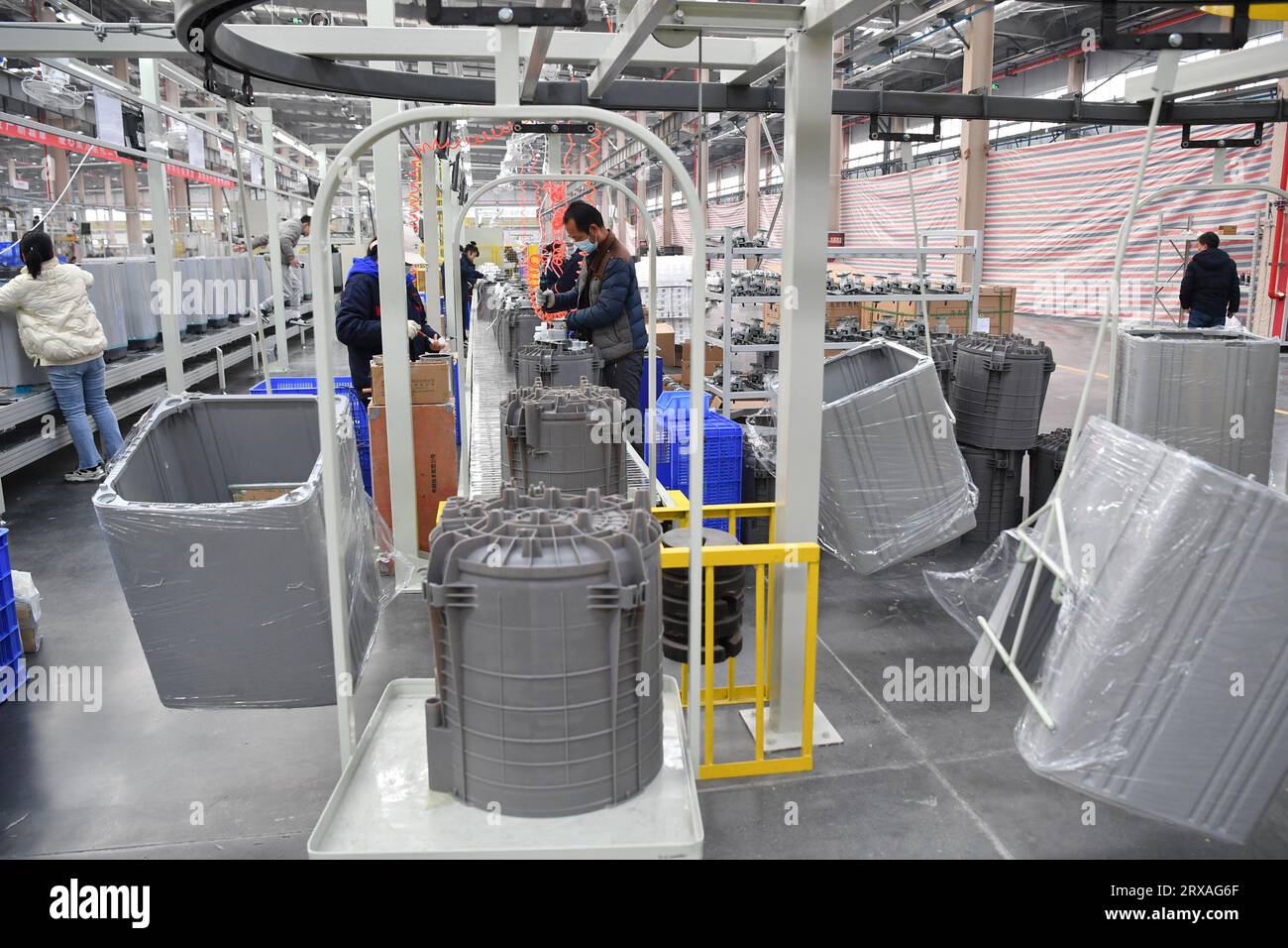 Xi'an, China's Shaanxi Province. 22nd Feb, 2023. Employees assemble washing machines on a production line of an electrical appliance company near Xi'an International Port in Xi'an, northwest China's Shaanxi Province, Feb. 22, 2023. The Chang'an China-Europe freight train service was launched in 2013, when China proposed the Belt and Road Initiative. In the past ten years, Xi'an International Port, the starting station of the Chang'an China-Europe freight trains, has been developed from a small cargo station to an international logistic hub. Credit: Shao Rui/Xinhua/Alamy Live News Stock Photo