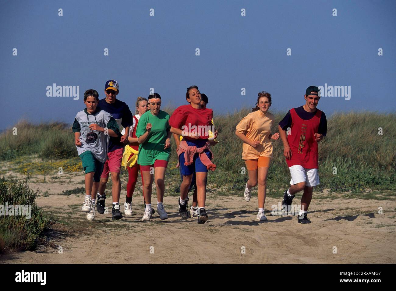 Young people jogging on the beach Stock Photo