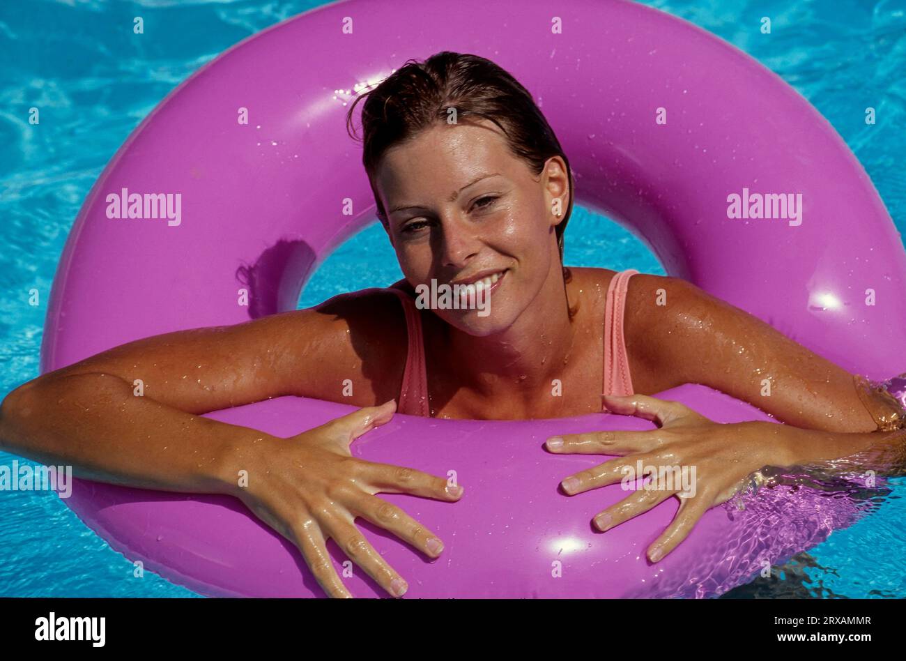 Young woman with swimming ring in swimming pool Stock Photo Alamy