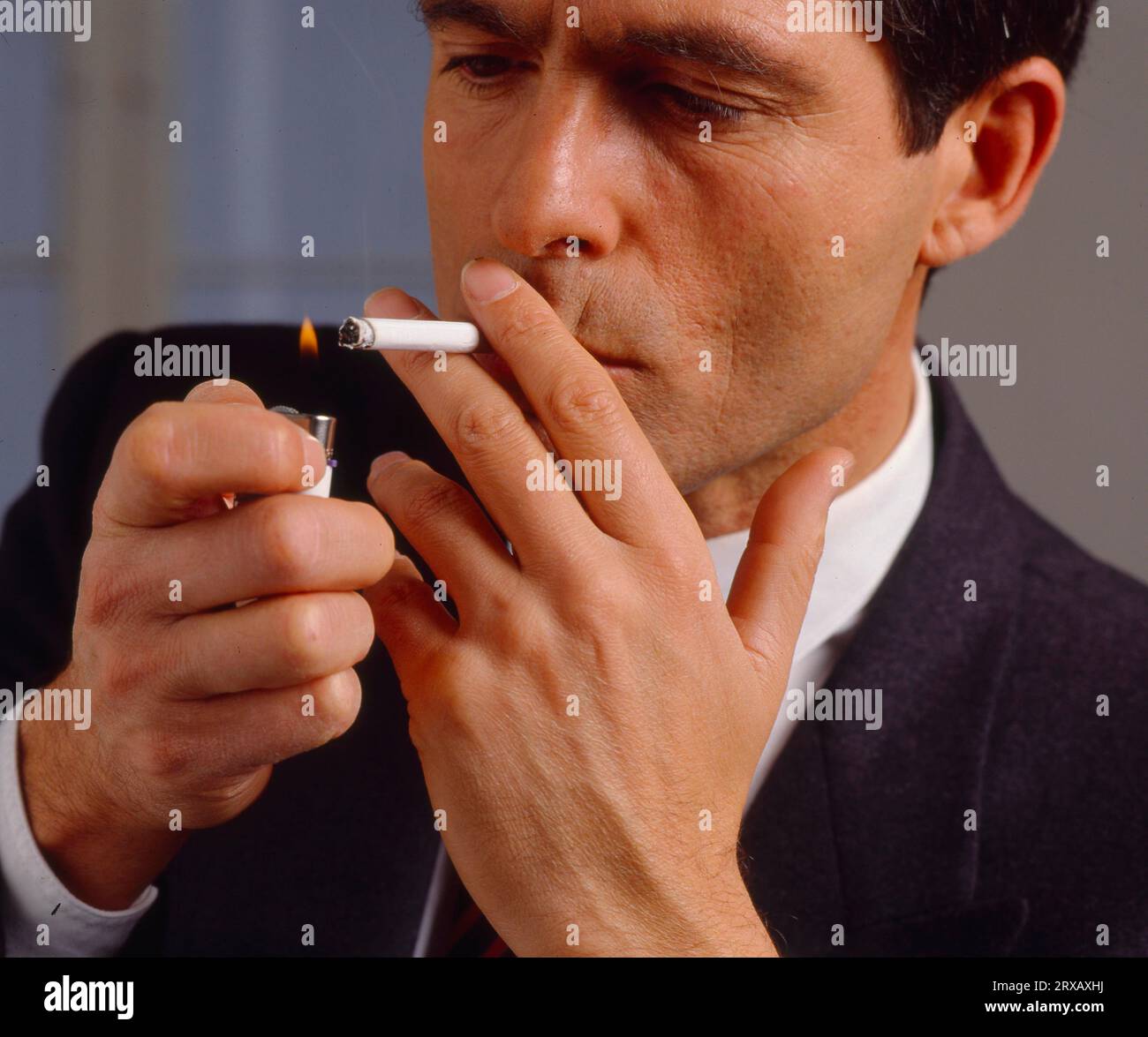 what is a light cigarette to smoke Man, light cigarettes and smoke Stock Photo