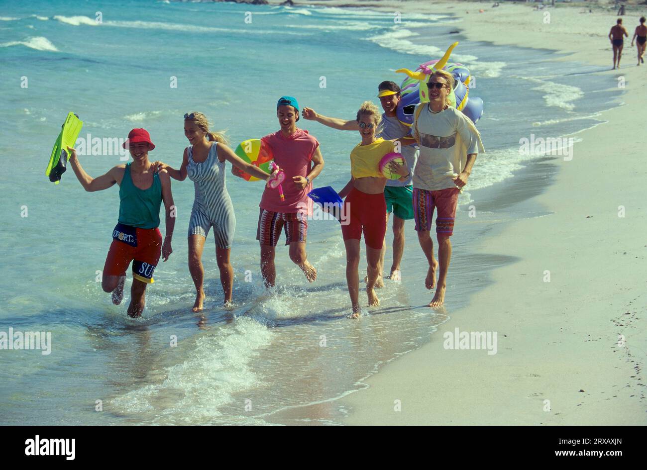 Young people on the sandy beach Stock Photo