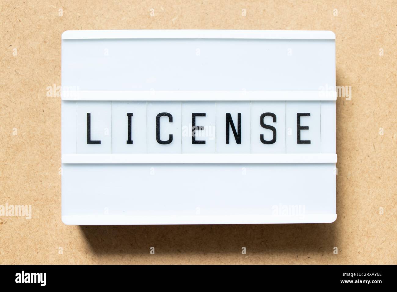 Lightbox with word license on wood background Stock Photo