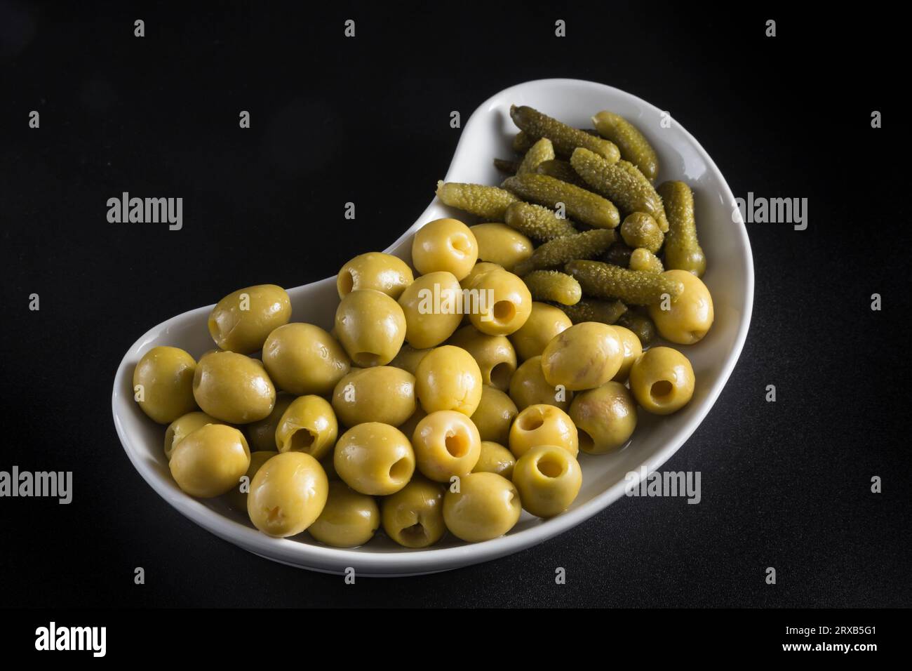 olives and pickles on a kidneyshaped tray, typical Spanish appetizer
