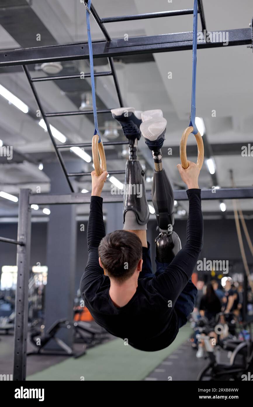 unbelievable workout with gymnastic rings. ambitious active guy raising