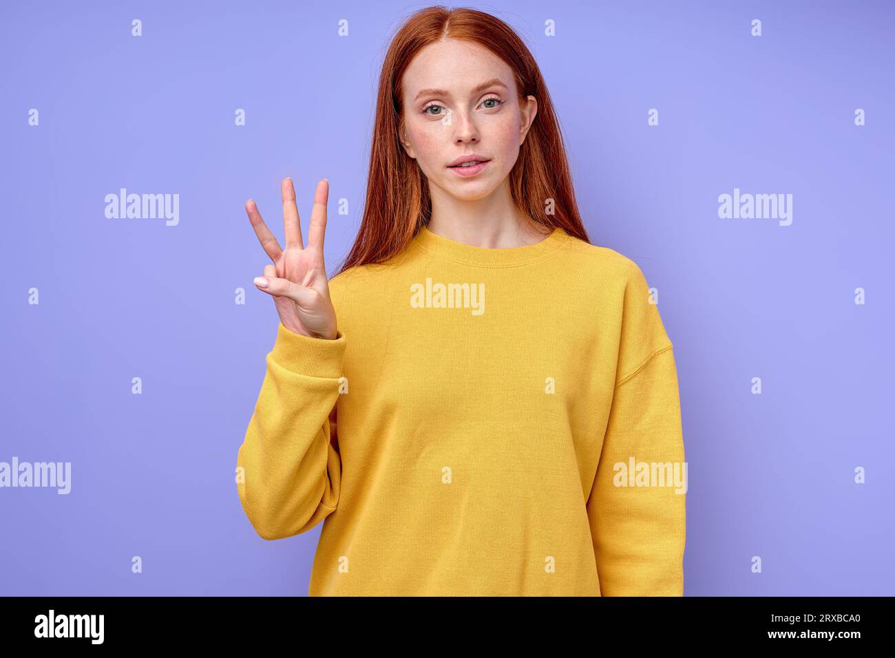 beautiful serious confident redhead woman in yellow stylish sweater ...