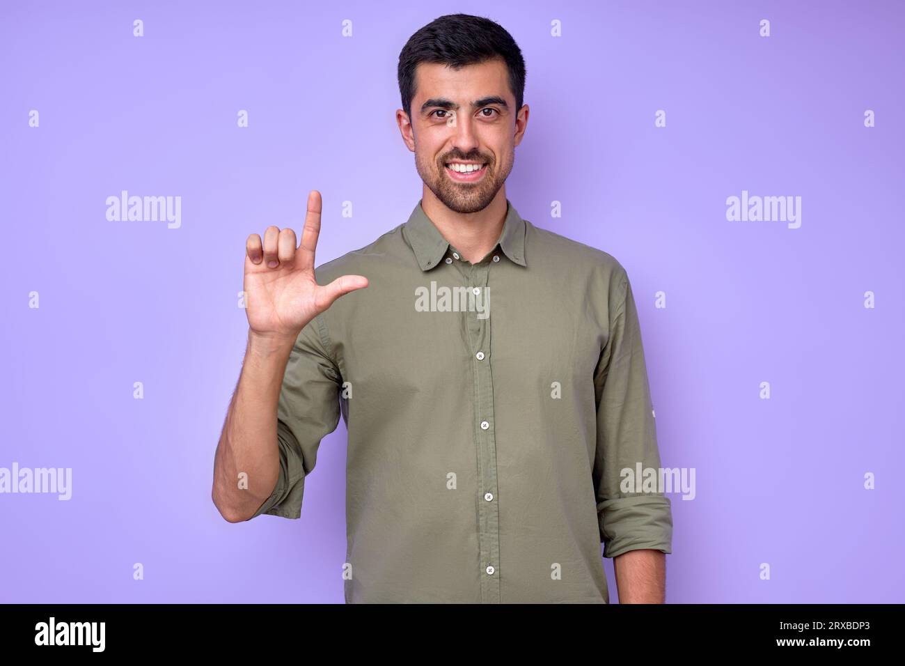 cheerful brunette bearded man demonstrating the letter L l. sign ...