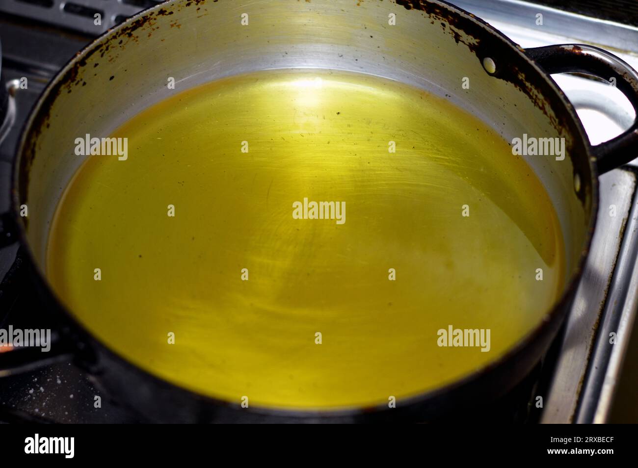 food oil in a pan ready for frying fast food, mixture of sunflower