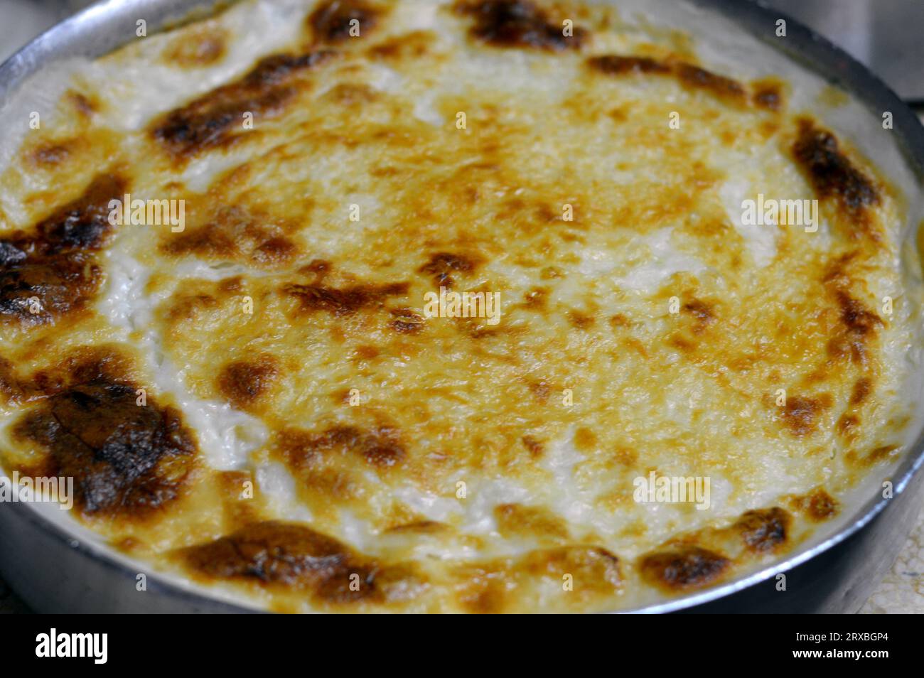 Baked Egyptian rice or Roz muammar's combination of rice, fresh cream, milk, ghee or butter, a very popular Egyptian dish, a simple, sumptuous Egyptia Stock Photo