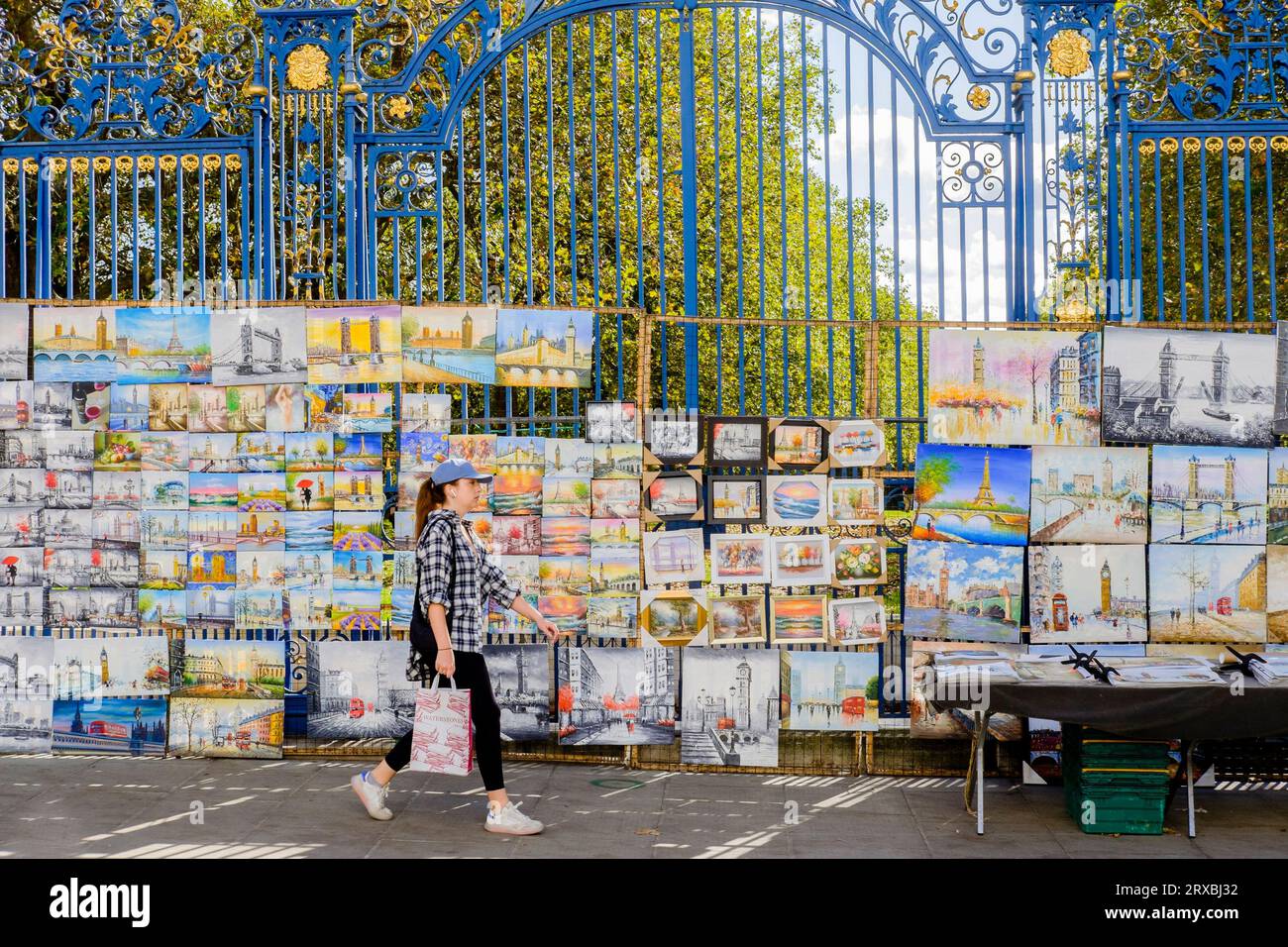 Paintings for sale hung on the railings of The Green Park at Piccadilly Art Market, London, UK Stock Photo