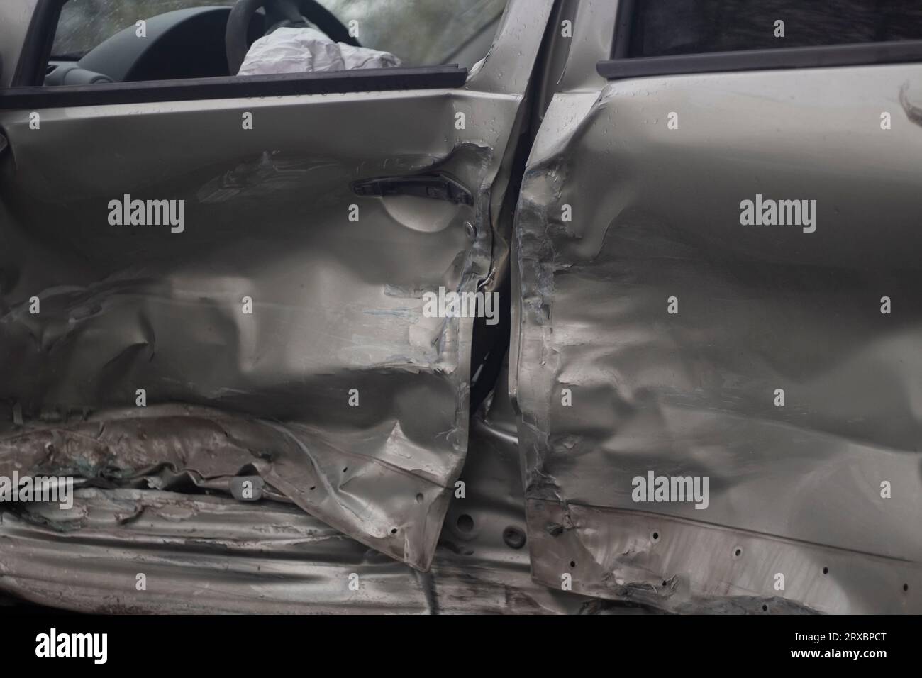Dent in the door. Broken car. Damaged vehicle body. Car in a landfill. Stock Photo