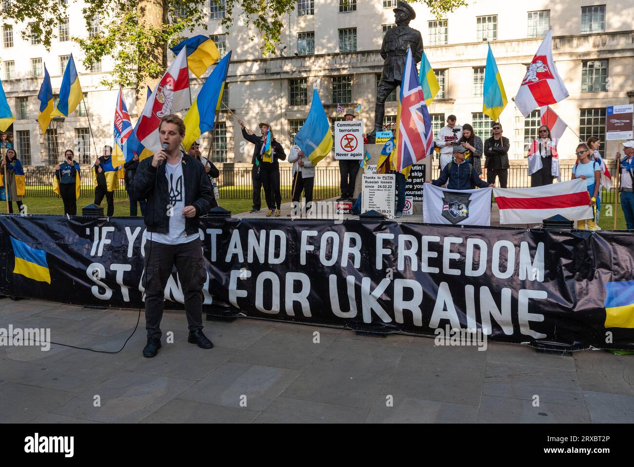 Protest taking place in Whitehall opposite Downing Street against the actions of Russia in Ukraine. If you Stand for Freedom, Stand for Ukraine banner Stock Photo