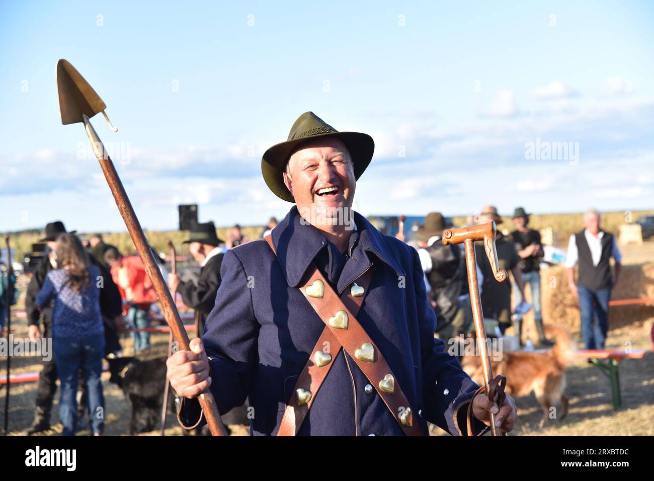 Brambach, Germany. 24th Sep, 2023. Mario Wehlitz from Saxony-Anhalt stands in traditional shepherd costume at the award ceremony for the national herding competition. In his hand he holds the Golden Shovel, which he won as the winner of the German Shepherding Championship. Credit: Simon Kremer/dpa/Alamy Live News Stock Photo