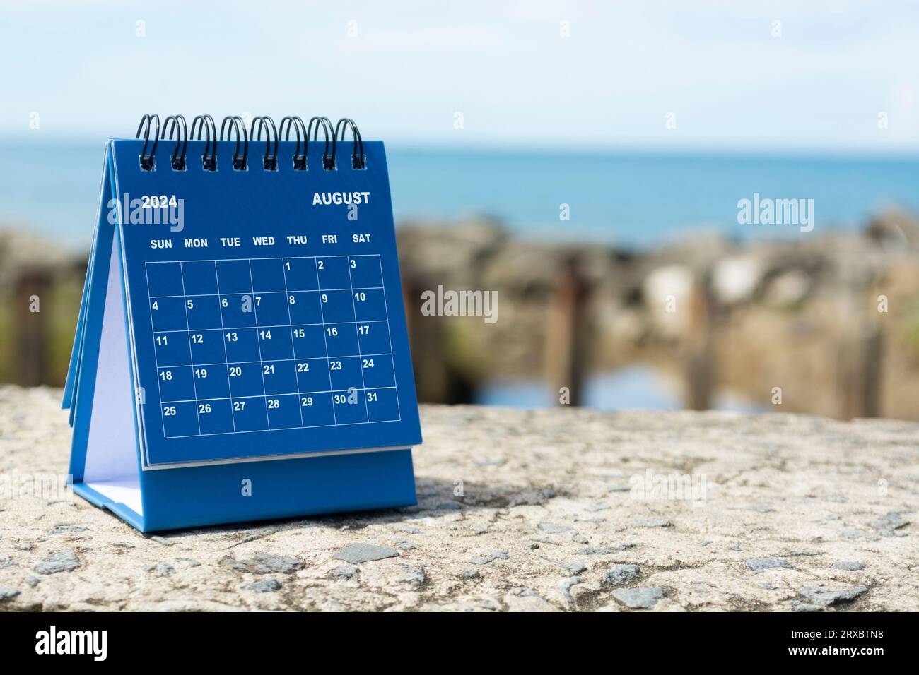 Blue August 2025 calendar on blurred background of blue ocean. 2025 New