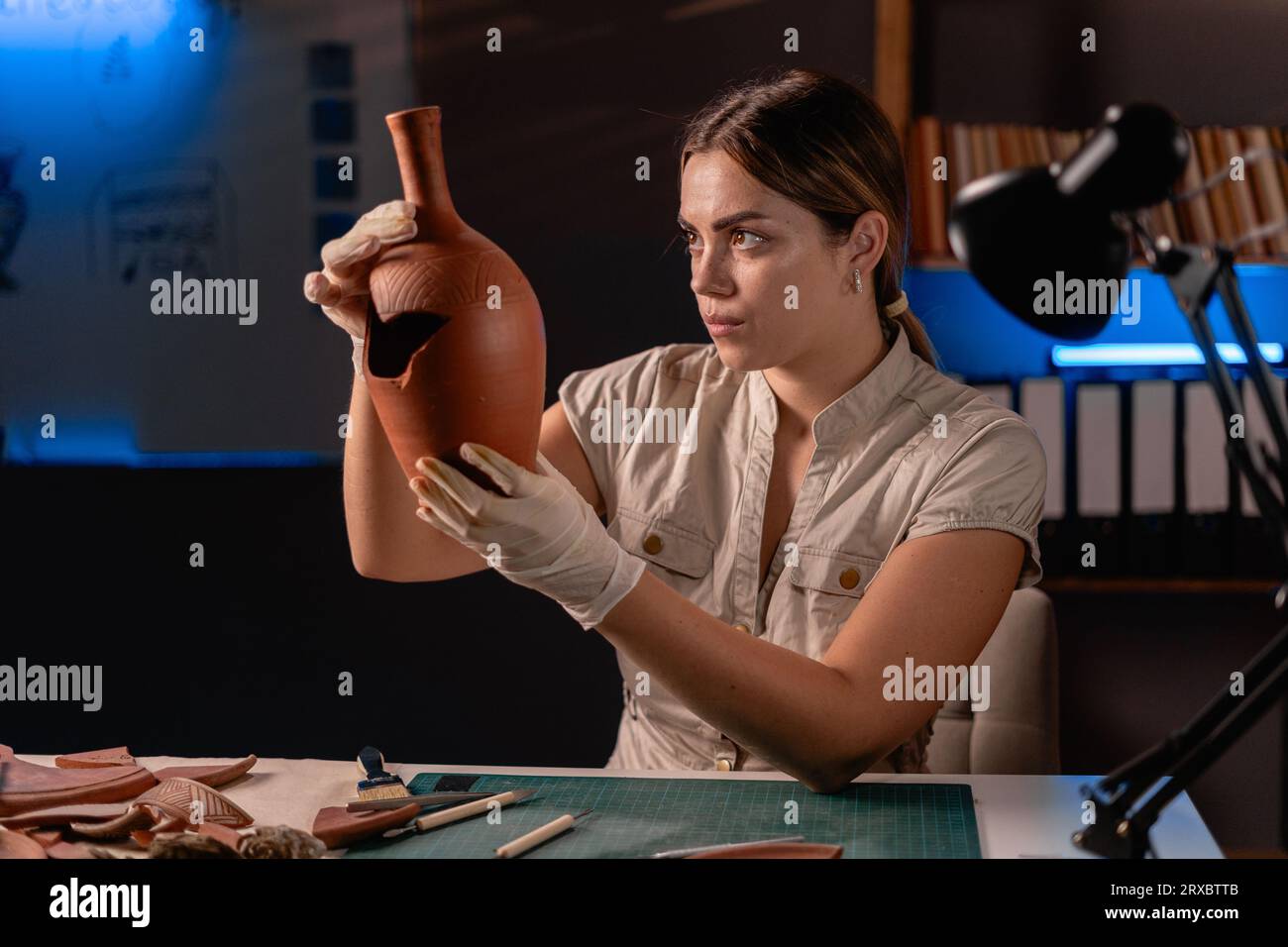 Female archeologist work late night in office research ancient