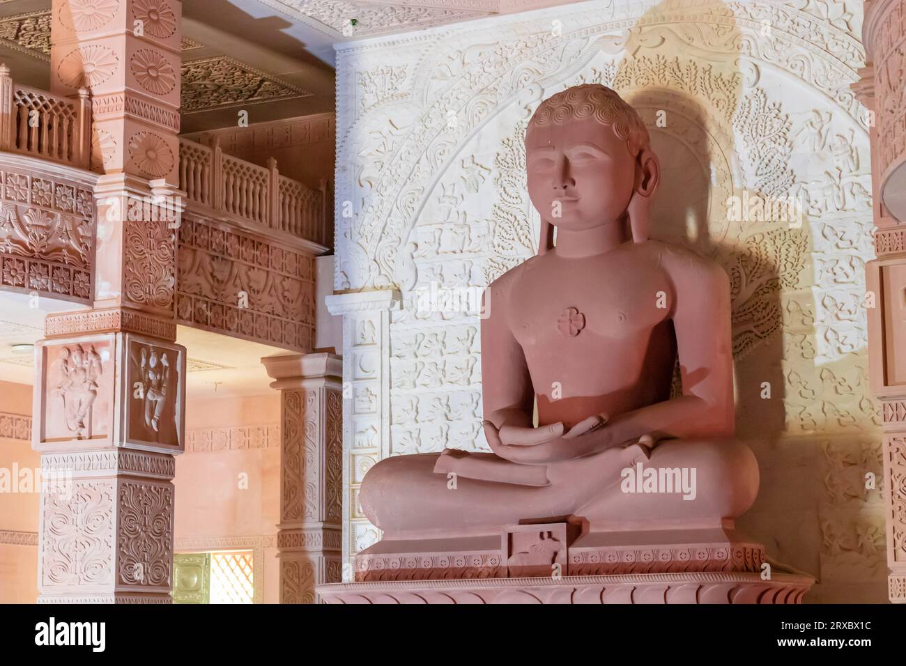 isolated red stone jain god holy statue in meditation from different angle image is taken at Shri Digamber Jain Gyanoday Tirth Kshetra, Nareli Jain Ma Stock Photo