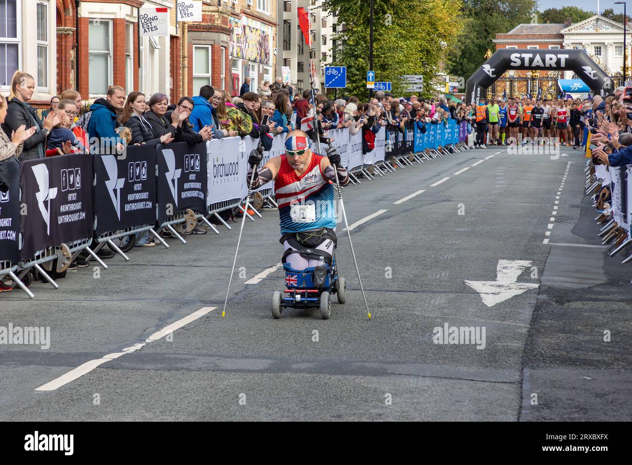 Warrington, Cheshire, UK. Sunday 24 September 2023 - Warrington, Cheshire, England, UK - The world's first free to enter, chipped and closed roads running festival took place and Injured and arthritic ex-soldier, Steven Hughes, begins alone on a para Nordic roller sitski before the runners start their race. Credit: John Hopkins/Alamy Live News Stock Photo