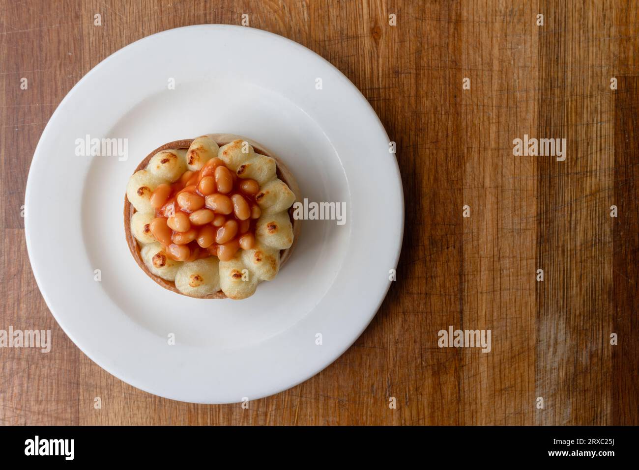 Scottish pie served with mashed potatoes and baked beans Stock Photo