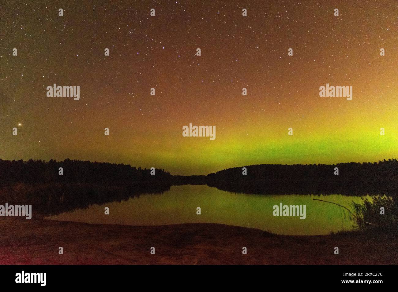 night image of a massive multicolored green vibrant Aurora Borealis