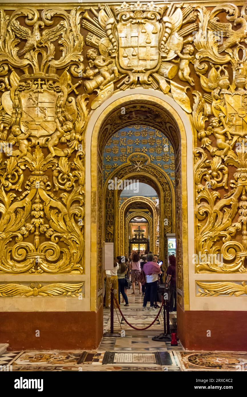 Valletta; Malta - 17 June 2023: Gold decorated arches spanning the side aisles in Valletta Cathedral; Malta Stock Photo