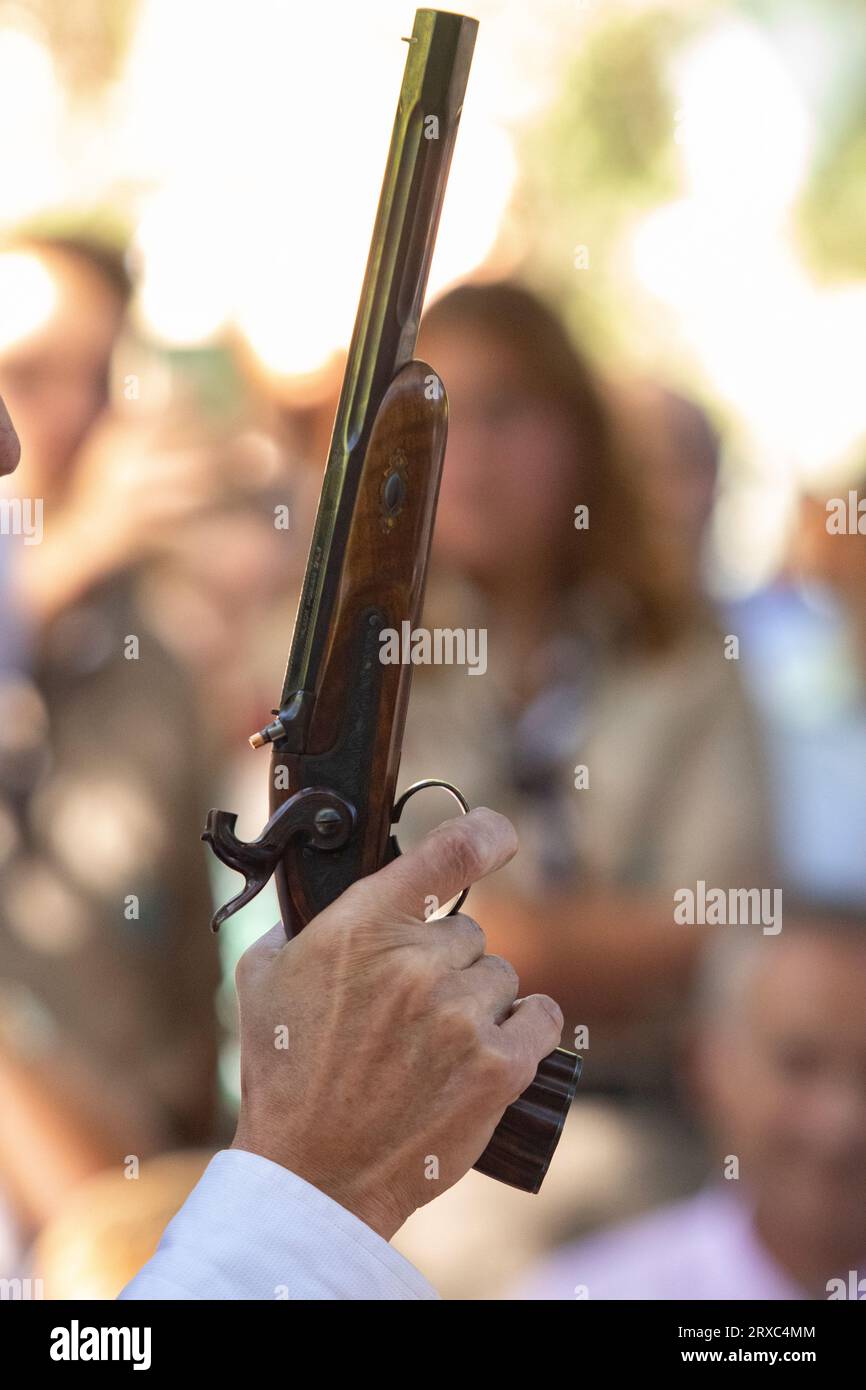 Hand holding flintlock pistol with blur background Stock Photo