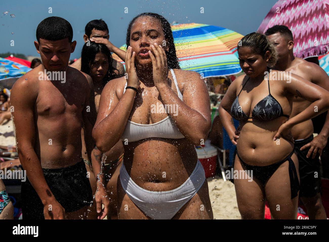 Brazilian girls taking shower on Ipanema beach 