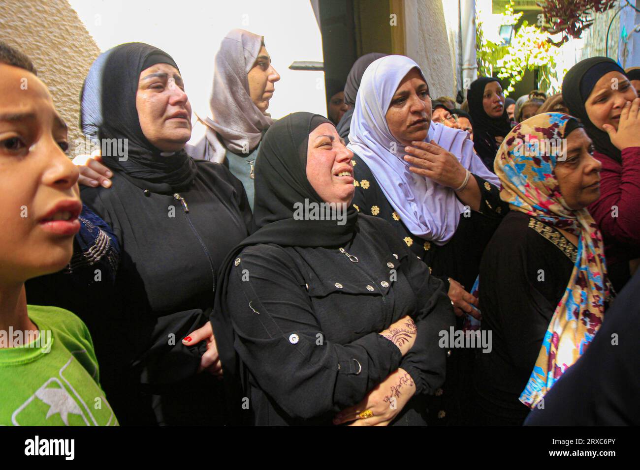 Relatives mourn seen during the funeral of two Palestinians who were