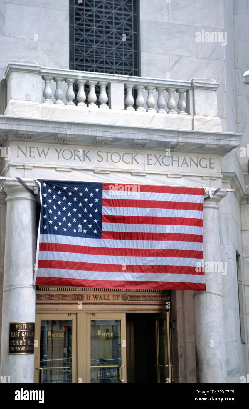 American flag in front of the entrance of the New York Stock Exchange at 11 Wall Street, NY, USA Stock Photo