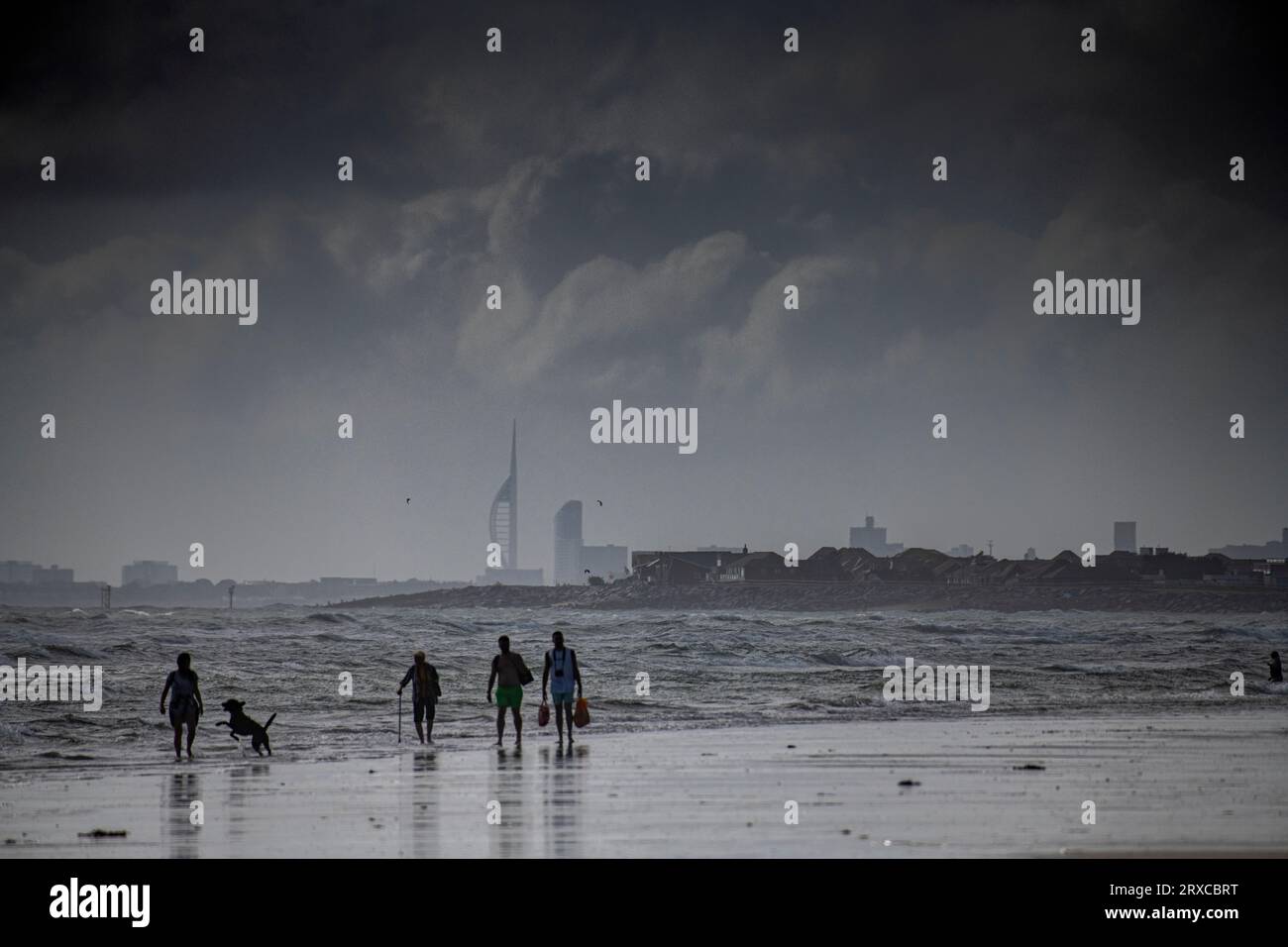 A cloudy day on West Wittering beach with Portsmouth and the Spinnaker Tower in the distance Stock Photo