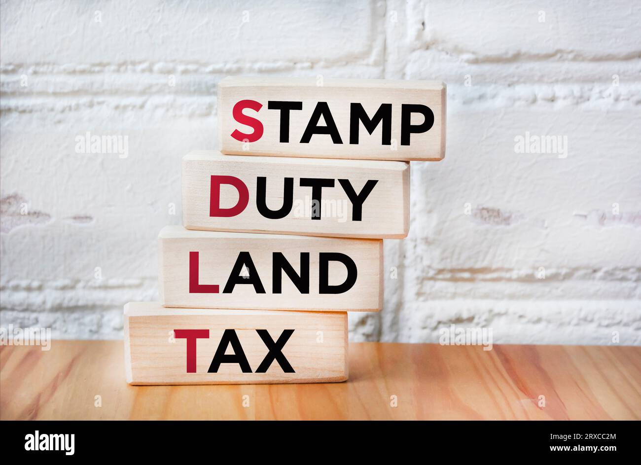 SDLT Stamp Duty, Land Tax written on blocks on an office desk Stock