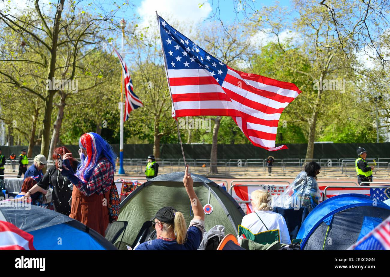 American flag being waved at the camp site on the Mall London in the lead up to King Charles coronation showing tents and Union Jack. Stock Photo