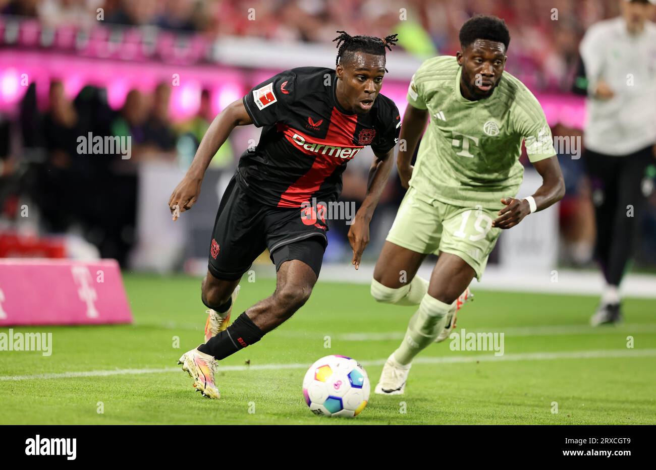 Jeremie FRIMPONG (Bayer 04 Leverkusen, #30) in a duel with Jakub KAMINSKI  (VfL Wolfsburg, #16), Stock Photo, Picture And Rights Managed Image. Pic.  PAH-321123917
