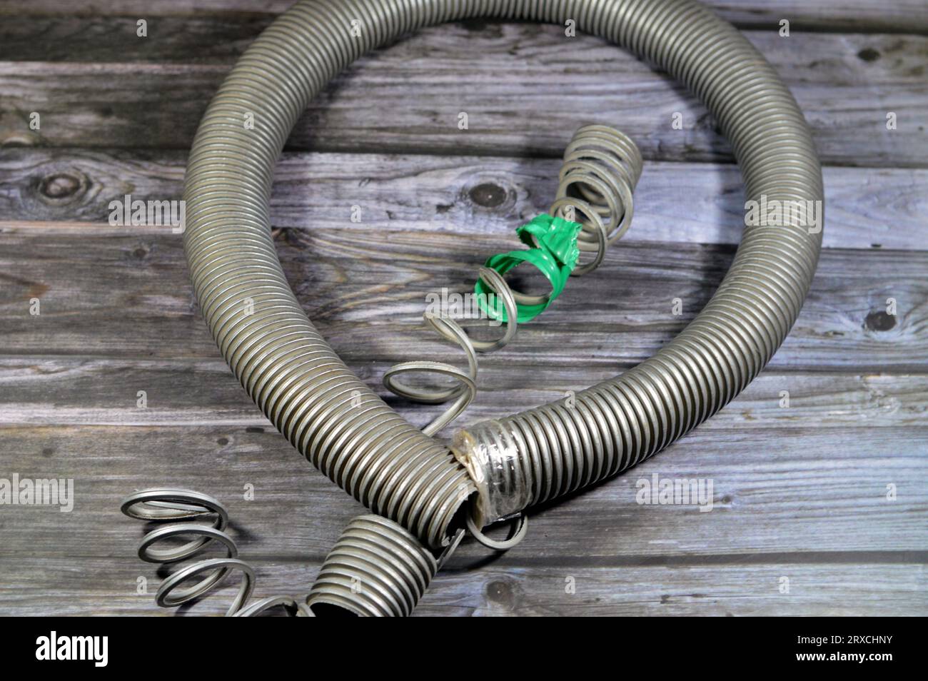 A broken flexible hose from a vacuum cleaner, substandard materials and
