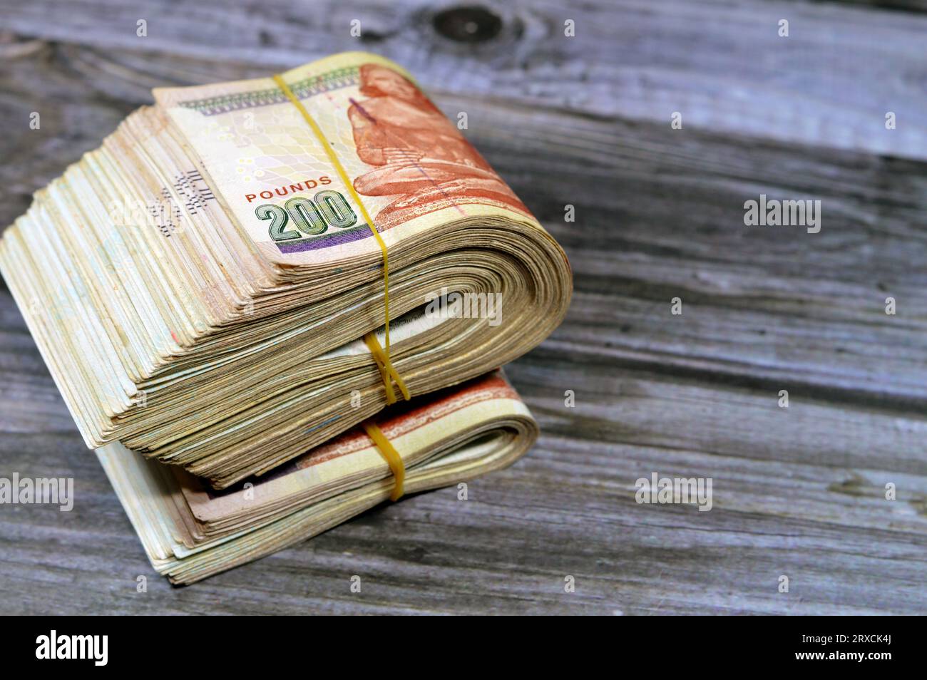 Folded Egyptian money isolated on wooden background, 200 LE two hundred ...
