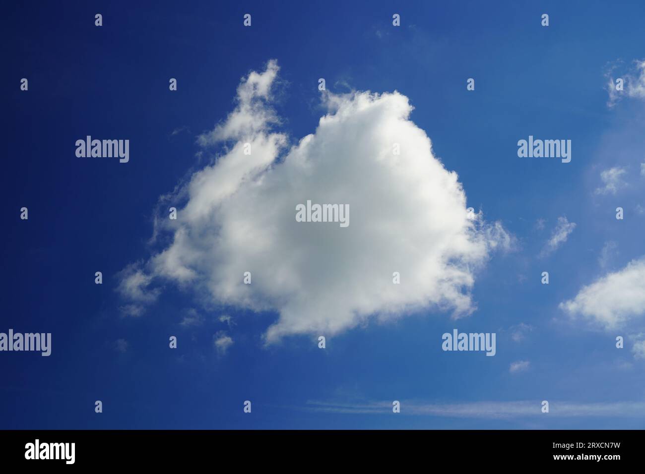 Fluffy white cumulus cloud against blue sky Stock Photo