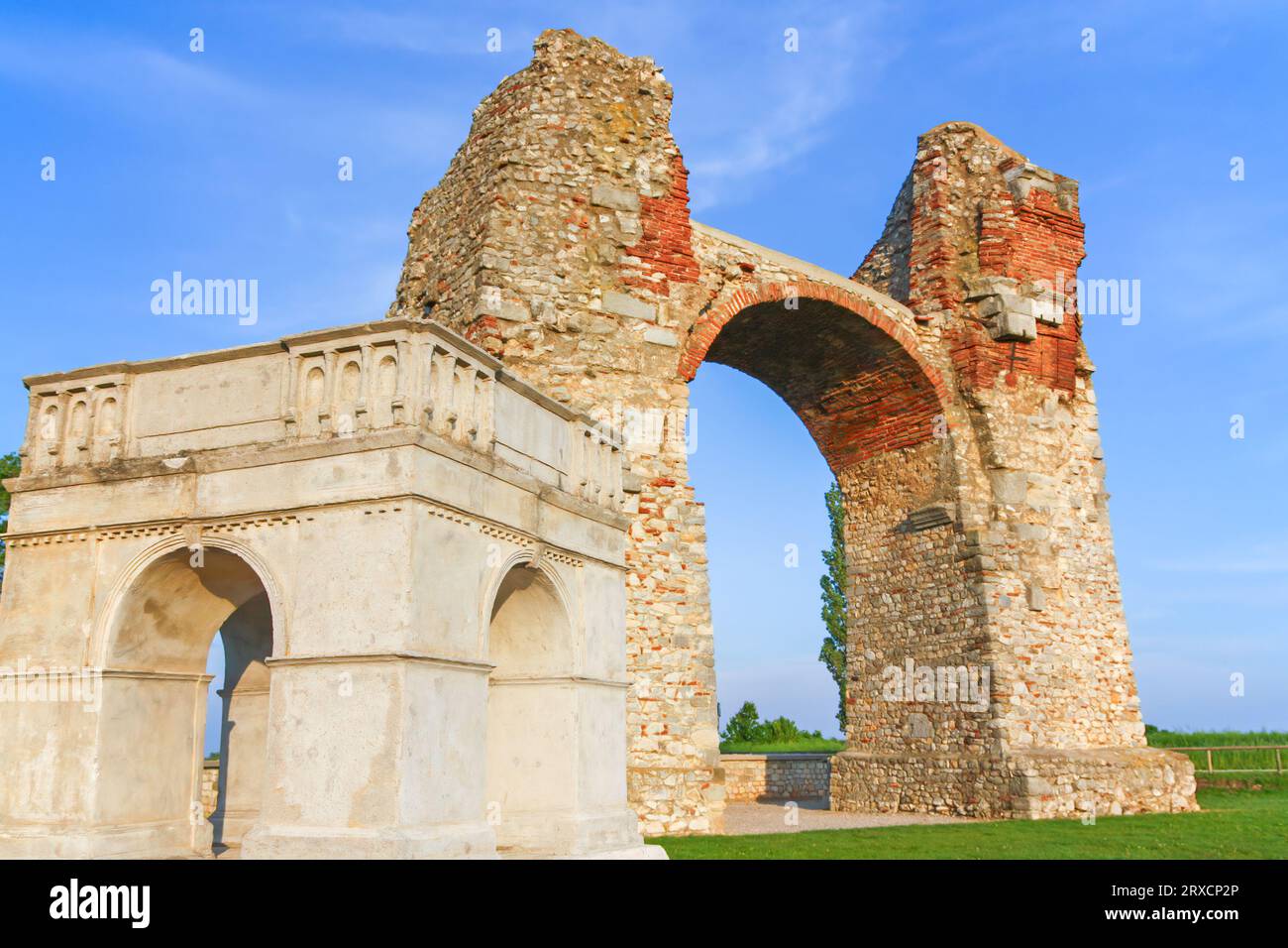 Old Roman City Gate (Heidentor) at Carnuntum in Austria, Europe. The model of the original building is in the foreground. Horizontally. Stock Photo