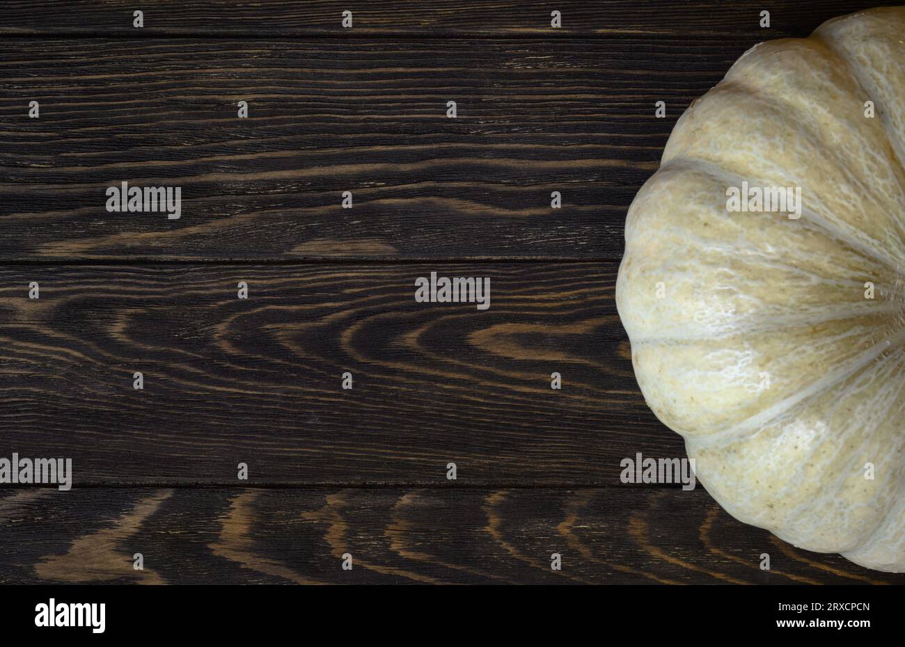Vintage wood texture background for Halloween theme, top view. Dark brown wooden planks and white pumpkin, ripe vegetable. Hallowen, thanksgiving, foo Stock Photo