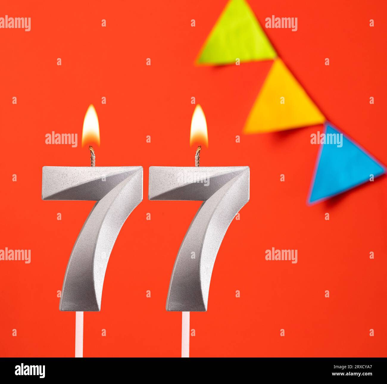 Birthday candle number 77 - Invitation card in orange background Stock Photo